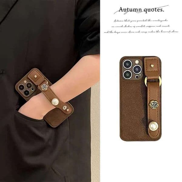 Elegant Brown Leather iPhone Case with Pearl Camellia Wrist Strap, Full Protection Cover Compatible with iPhone 17 Pro Max/16/15
