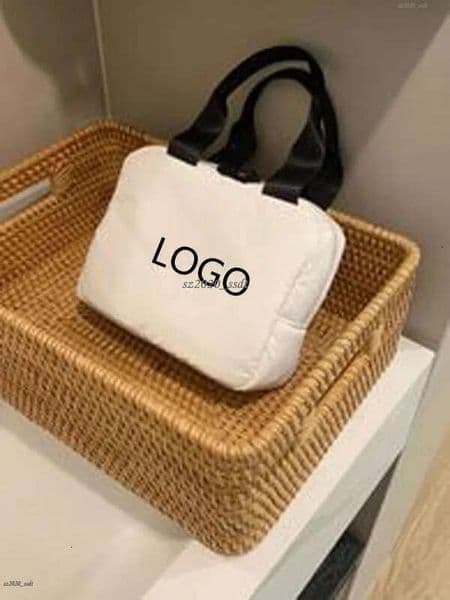 Designer's white handbag with embroidered letter logo, c