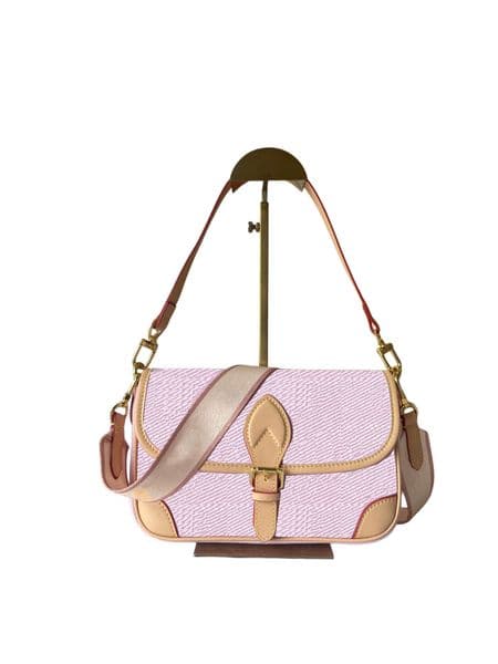 This designer shoulder bag features a decorative belt-style buckle that is actually a magnetic closure, making it quite convenient to open and close; it also has a middle