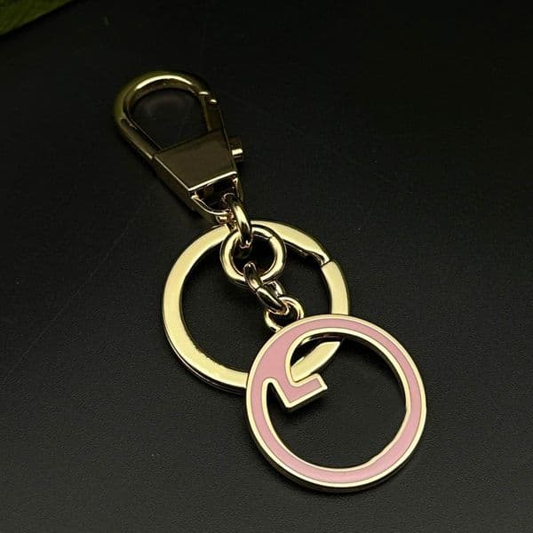 Designer Gold Tone Metal Keychains With Pink Enamel Circular Geometric Accent Elegant Daily Accessory Gifts For Her
