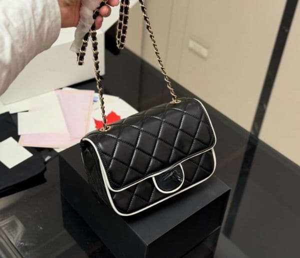 The classic chevron pattern meets simple white edge chains with multiple ways to wear the strap A timeless versatile piece that combines style with functionality