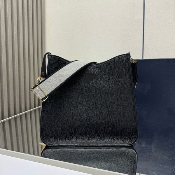 Master quality ss594 fabric crossbody/shoulder bag features a minimalist design with a unique logo on the front, adding a touch of iconic style.