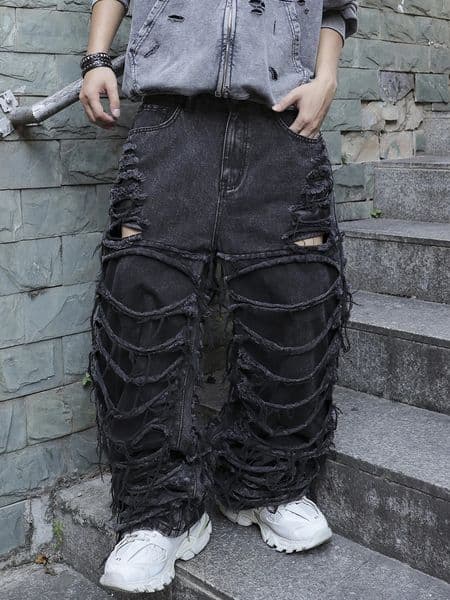 Mens black jeans With a of ripped holes and tassels In a street trend style 260605
