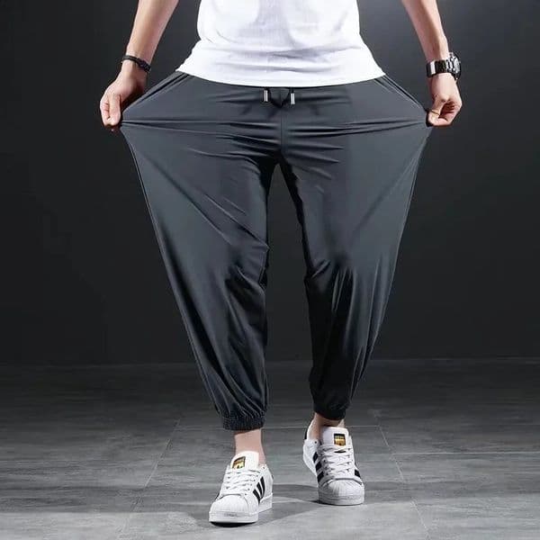 Summer quick drying silk casual pants mens ultrathin elastic nine point loose zipper solid beam leg 7XL 240815