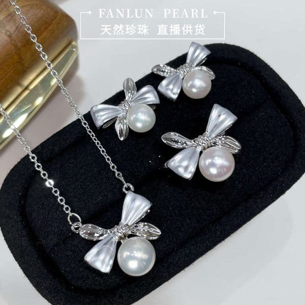 DH collections:New Simple Natural Pearl Bowknot Three-Piece Set for Women: High-End Ring, Earrings, Pendant, and Ear Studs
