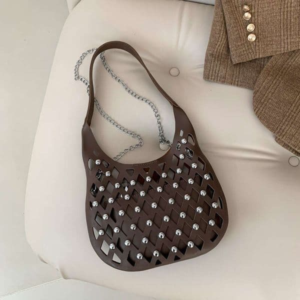 Small niche design for women hollowed out starry sky commuting armpit bag, fashionable rivet single shoulder crossbody bag 2024 new style, chic and elegant