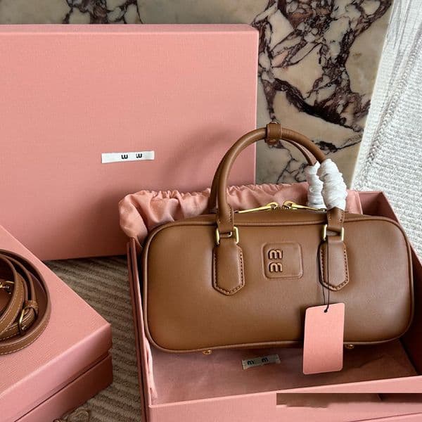 Designer bag,Stylish Handbag, boasts a sleek design with a embossed logo on the front and smooth leather exterior.