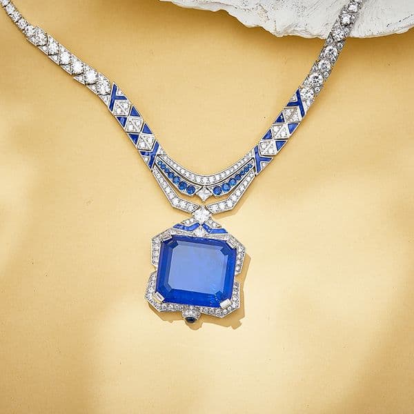 Sophisticated Designer Accessories: Lustrous Gold Tone Jewellery Piece Enhanced by Luxurious Green Gems