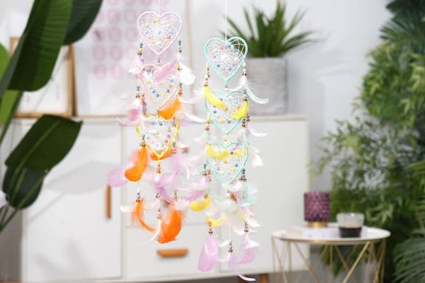 Handmade colorful heart-shaped dream-catching net with feather decorations