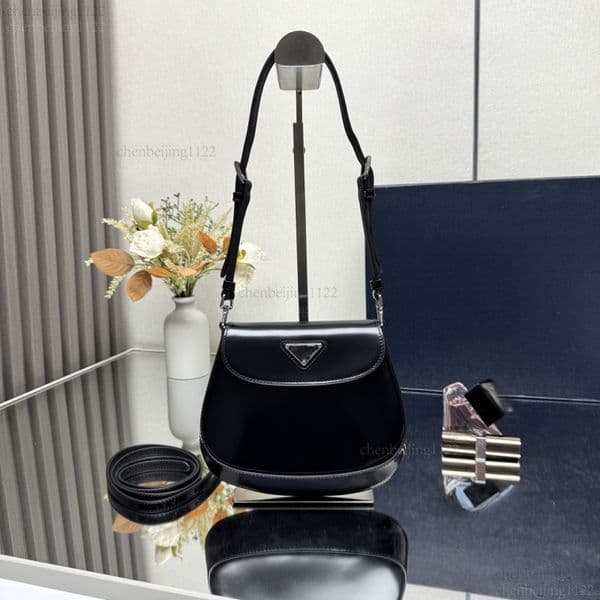99A This premium designer leather handbag features a crossbody strap and a shoulder strap. With its high-quality steel hardware, it tells a story of luxury and fashion.