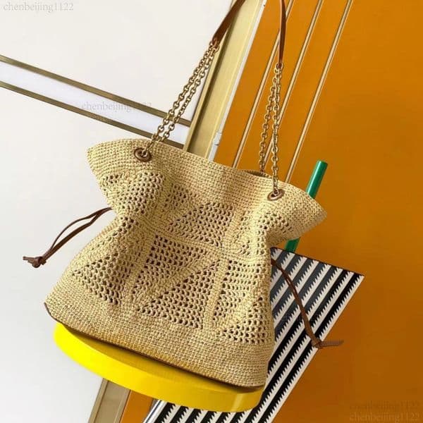 99A This top-notch designer handbag, crafted with exquisite hardware and made of pure handcrafted rattan, has a capacity of 35CM and is a must-have for summer.